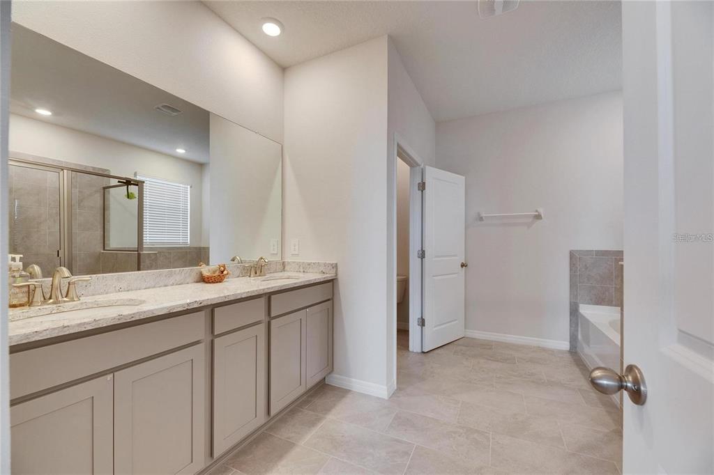 5125 Tannin Lane Lakewood Ranch, FL 34211 - Photo 19 of 45 a bathroom with a double vanity sink and mirror