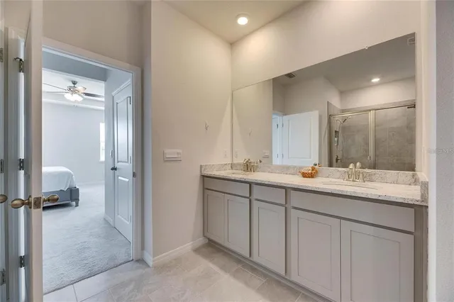 a bathroom with double sink and a mirror
