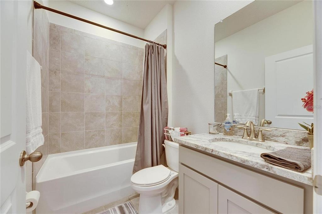 5125 Tannin Lane Lakewood Ranch, FL 34211 - Photo 23 of 45 a bathroom with a granite countertop sink toilet and shower