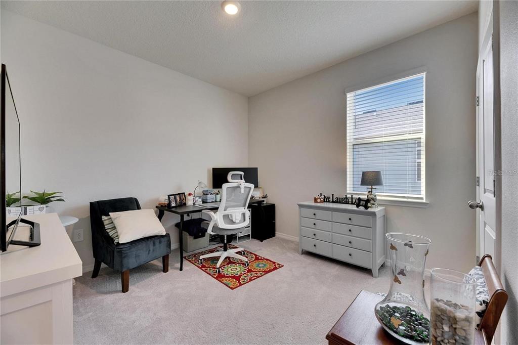 5125 Tannin Lane Lakewood Ranch, FL 34211 - Photo 24 of 45 a bedroom with furniture and a window