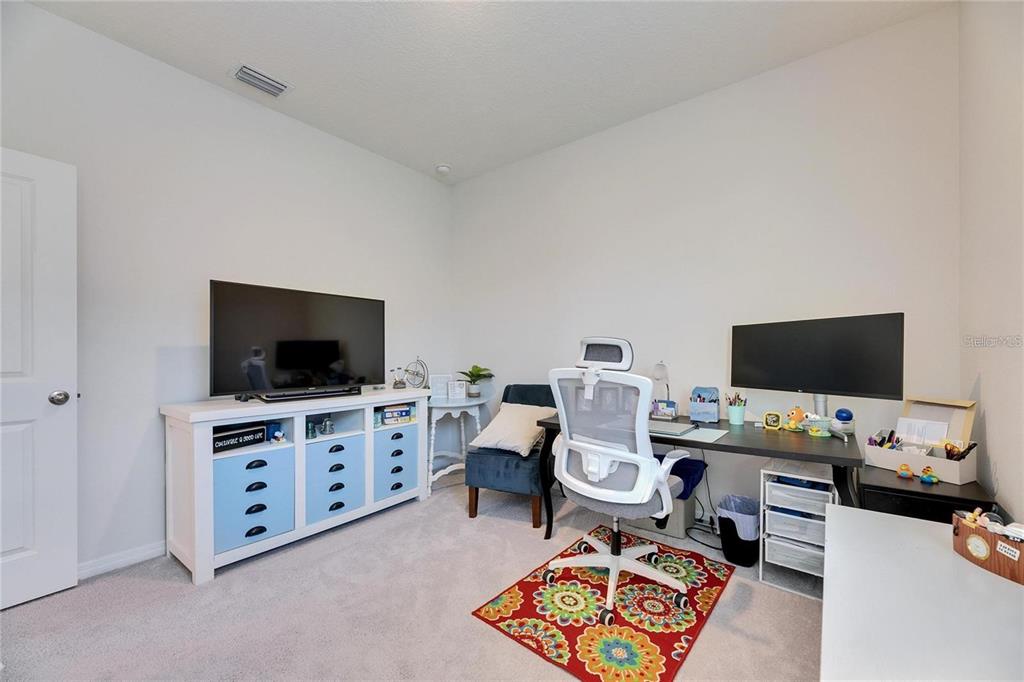 5125 Tannin Lane Lakewood Ranch, FL 34211 - Photo 26 of 45 a view of a workspace with furniture and a flat screen tv