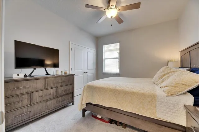 a bedroom with a bed and flat screen tv
