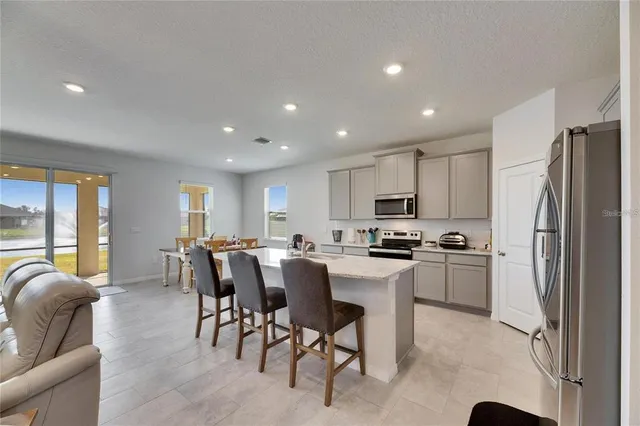 a kitchen with refrigerator and furniture