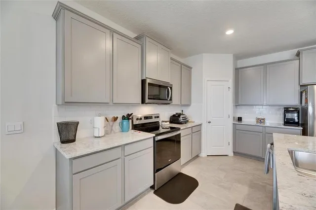 a kitchen with a sink stove and microwave