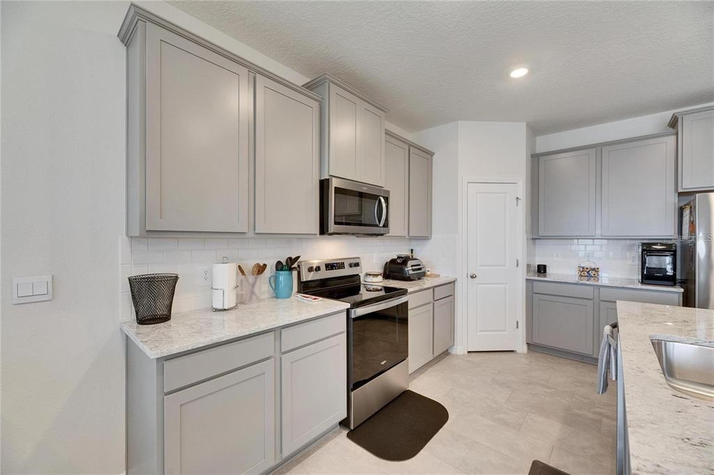 5125 Tannin Lane Lakewood Ranch, FL 34211 - Photo 7 of 45 a kitchen with a sink stove and microwave