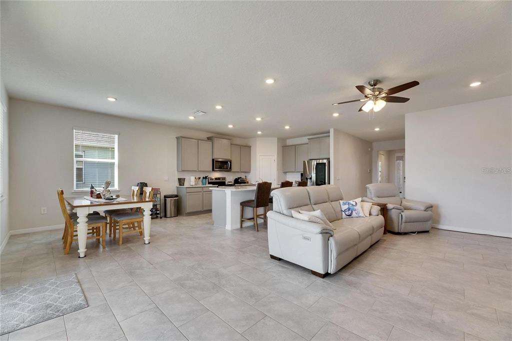 5125 Tannin Lane Lakewood Ranch, FL 34211 - Photo 8 of 45 a living room with furniture and kitchen view