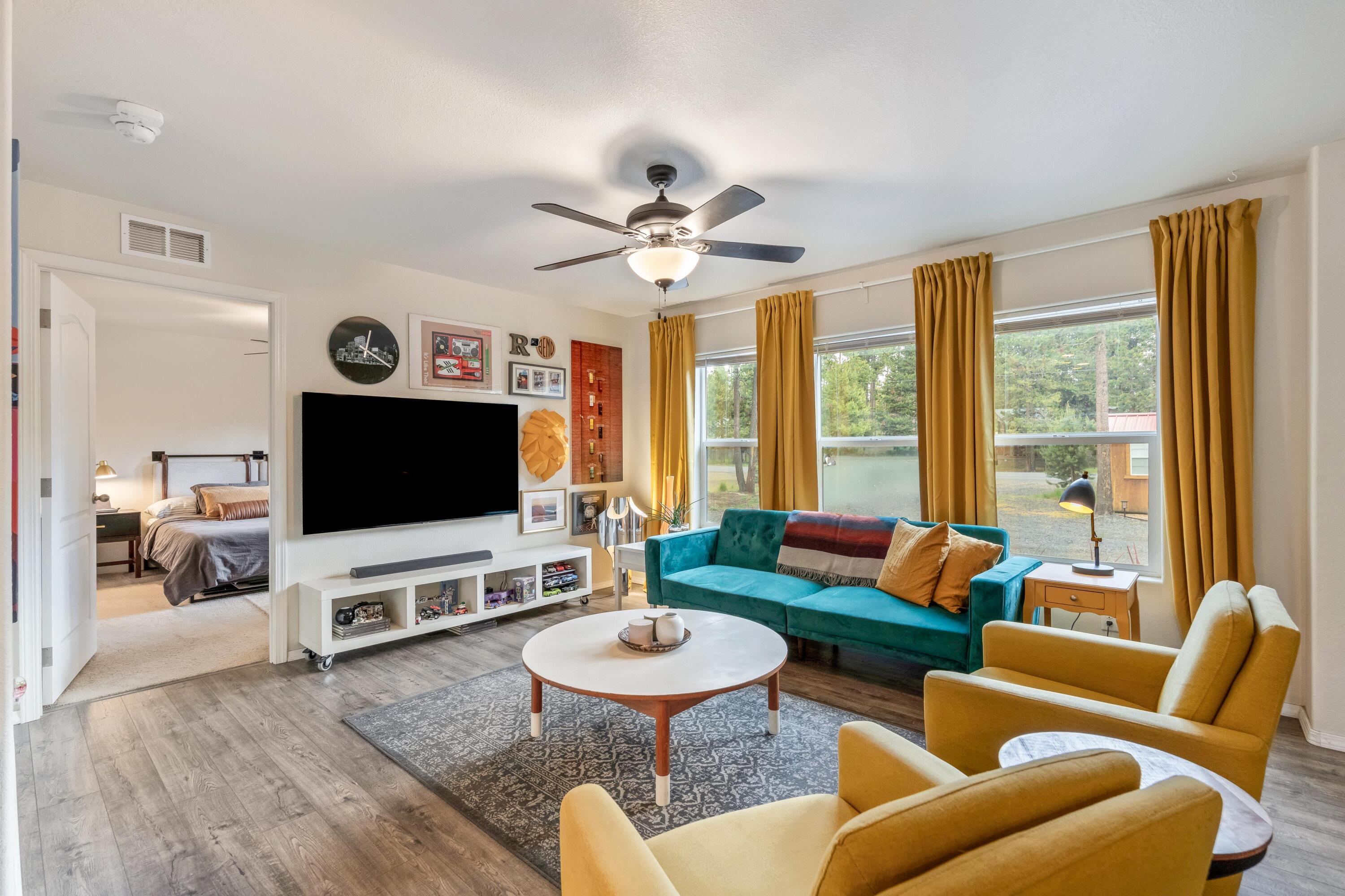 55823 Snow Goose Road Bend, OR 97707 - Photo 6 of 36 a living room with furniture and a flat screen tv