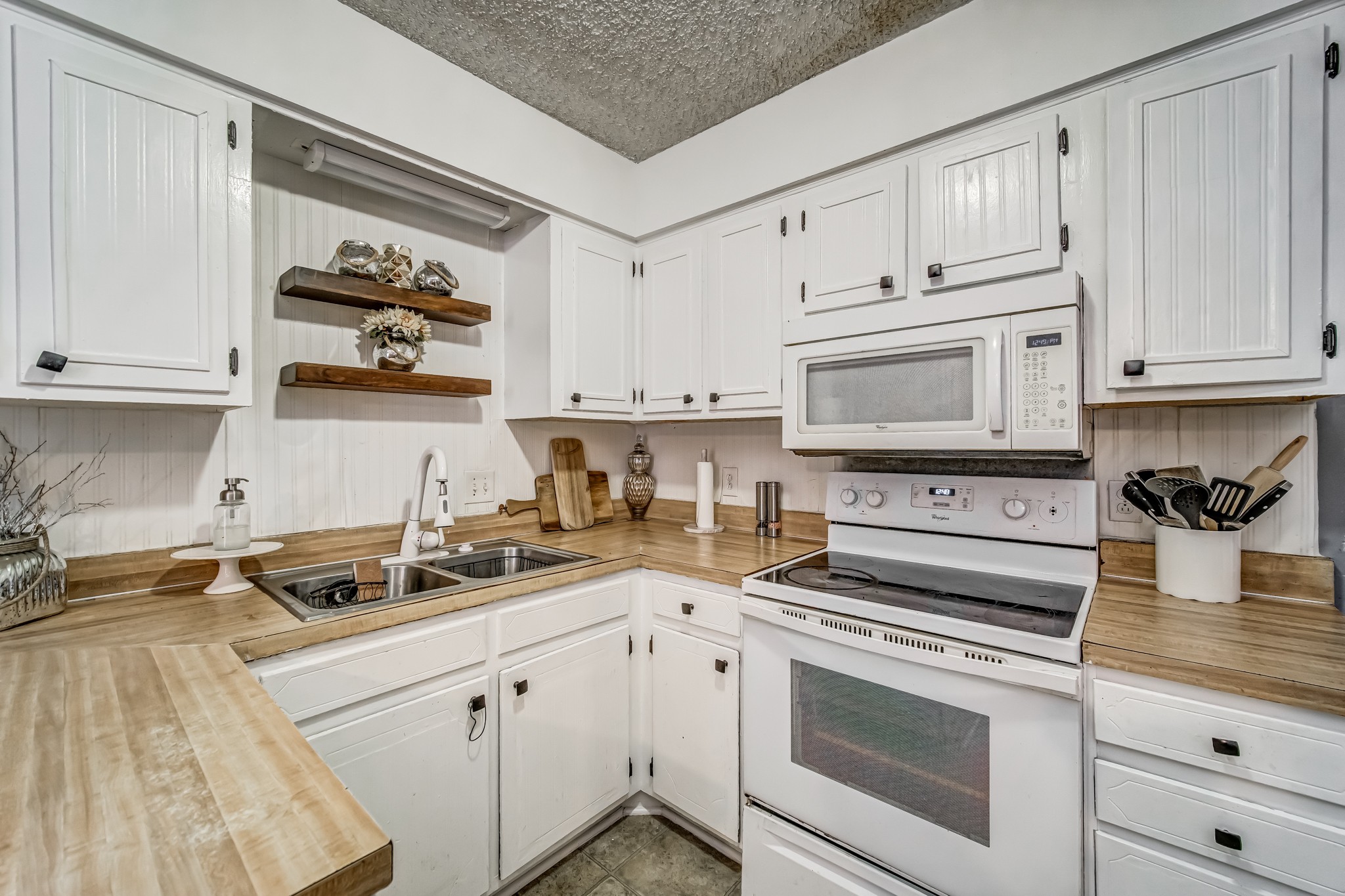 3325 Country Way Road Antioch, TN 37013 - Photo 15 of 37 a kitchen with granite countertop white cabinets and white appliances