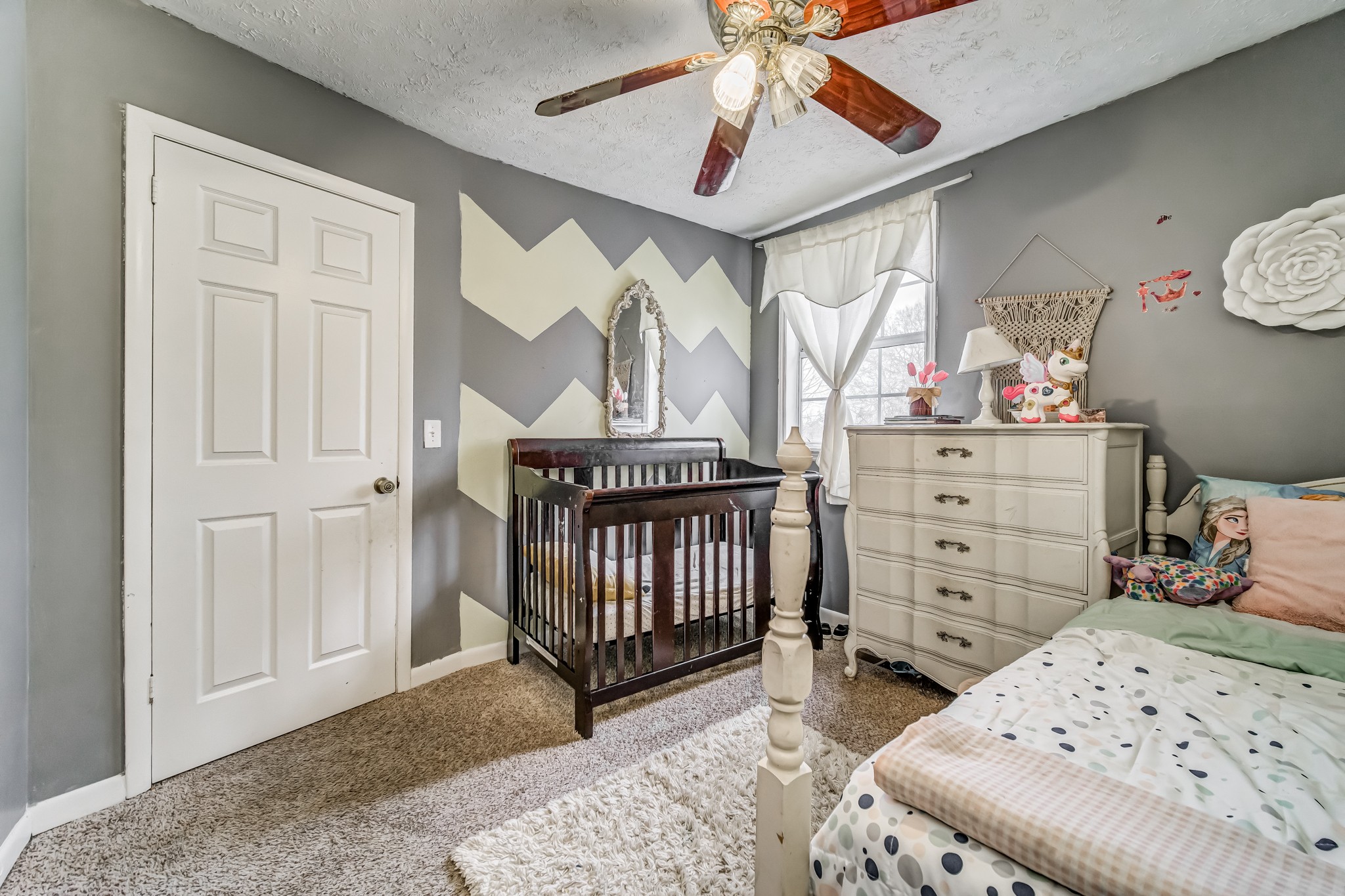 3325 Country Way Road Antioch, TN 37013 - Photo 33 of 37 a bedroom with a baby bed a chandelier and dresser