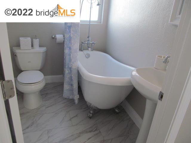 2807 Filbert Street Oakland, CA 94608 - Photo 10 of 29 a white toilet sitting next to a white sink