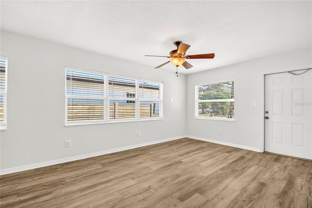 13440 1st Street East Madeira Beach, FL 33708 - Photo 29 of 44 a view of an empty room with wooden floor and a window