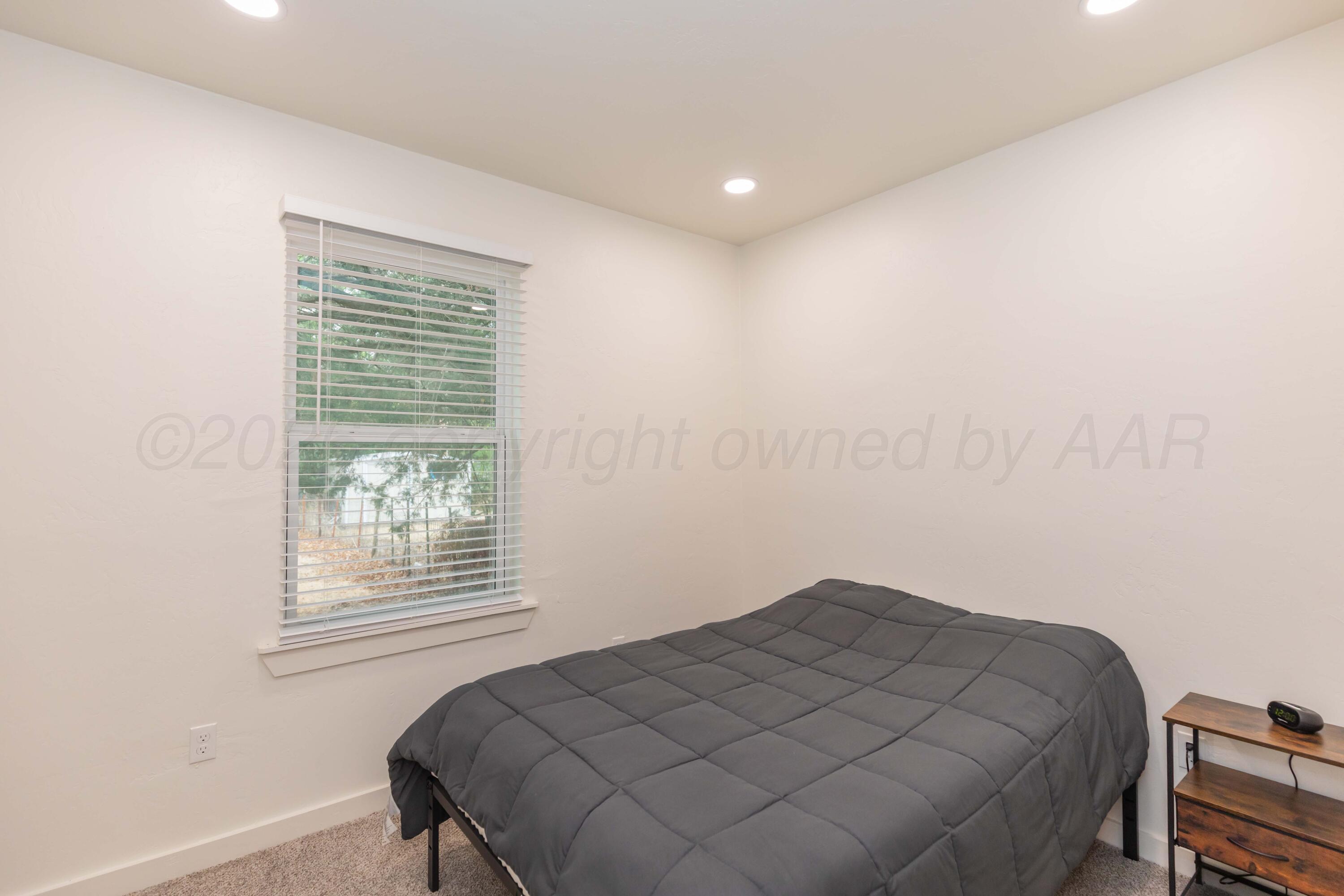 504 High Street Claude, TX 79019 - Photo 13 of 39 a bedroom with a bed and a window