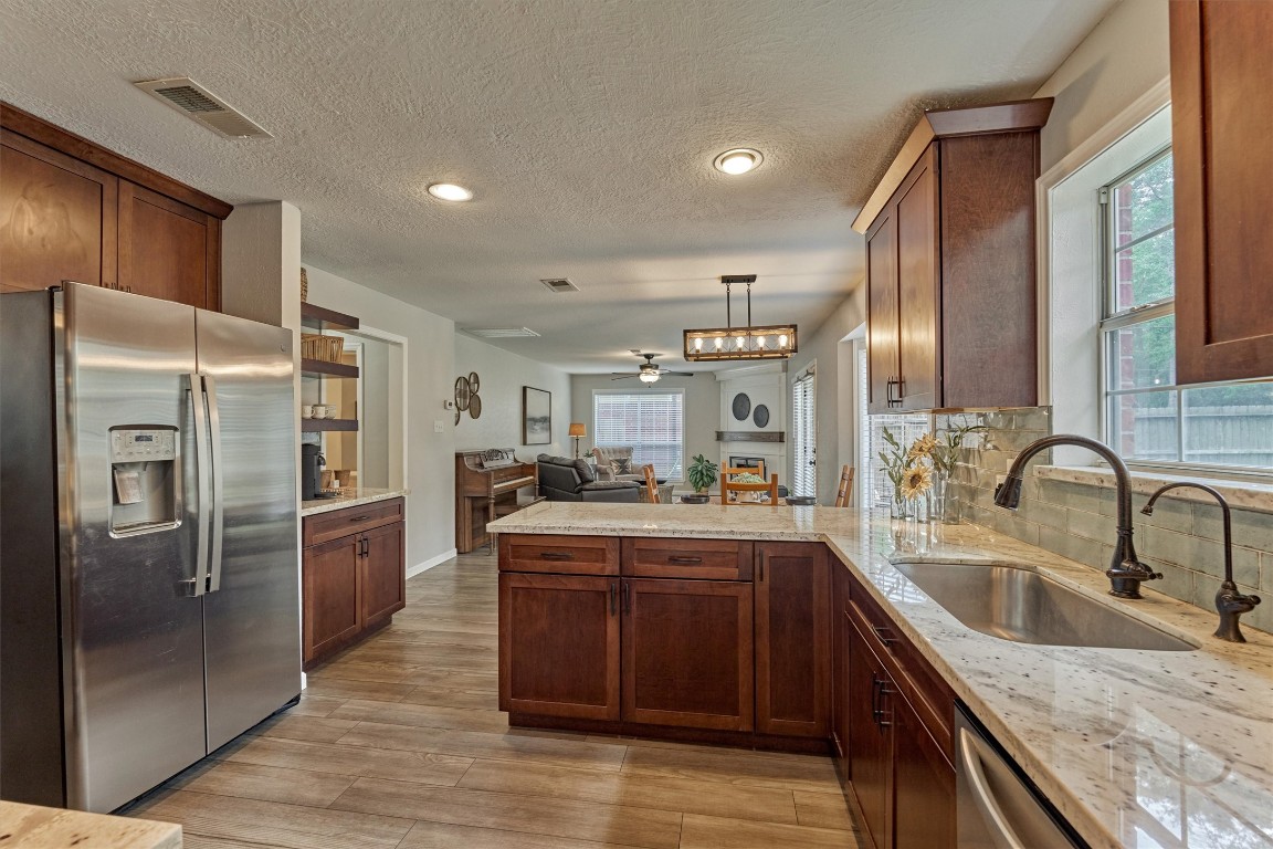 19 Greentwig Place Spring, TX 77381 - Photo 14 of 37 Kitchen is open to breakfast area and Family room. Note: water spigot on right of faucet has been replaced with soap dispenser.