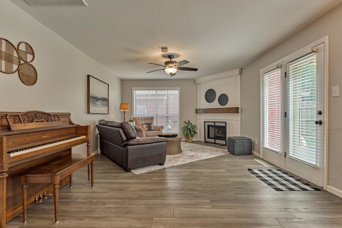 19 Greentwig Place Spring, TX 77381 - Photo 16 of 37 Family room with fireplace and tons of natural light.