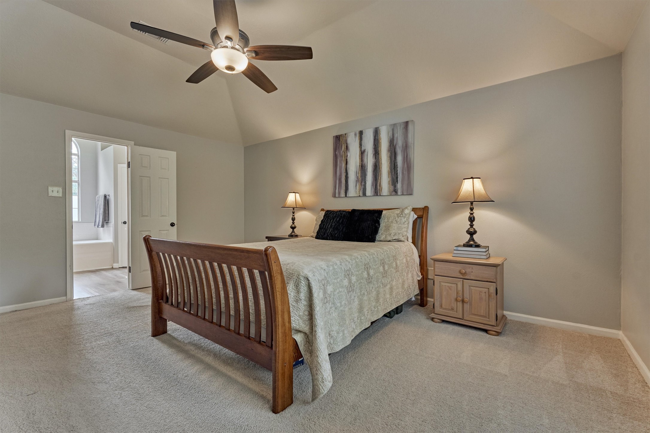 19 Greentwig Place Spring, TX 77381 - Photo 21 of 37 a bedroom with bed and a chandelier