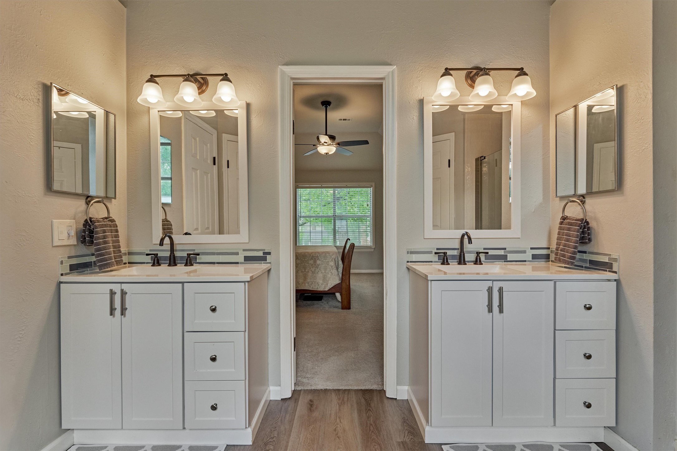 19 Greentwig Place Spring, TX 77381 - Photo 23 of 37 a bathroom with double vanity sinks and a mirror