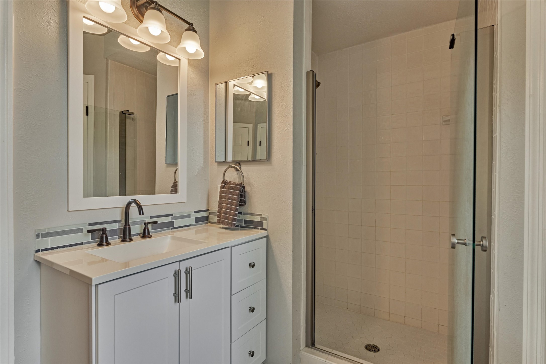 19 Greentwig Place Spring, TX 77381 - Photo 24 of 37 a bathroom with a sink and a mirror