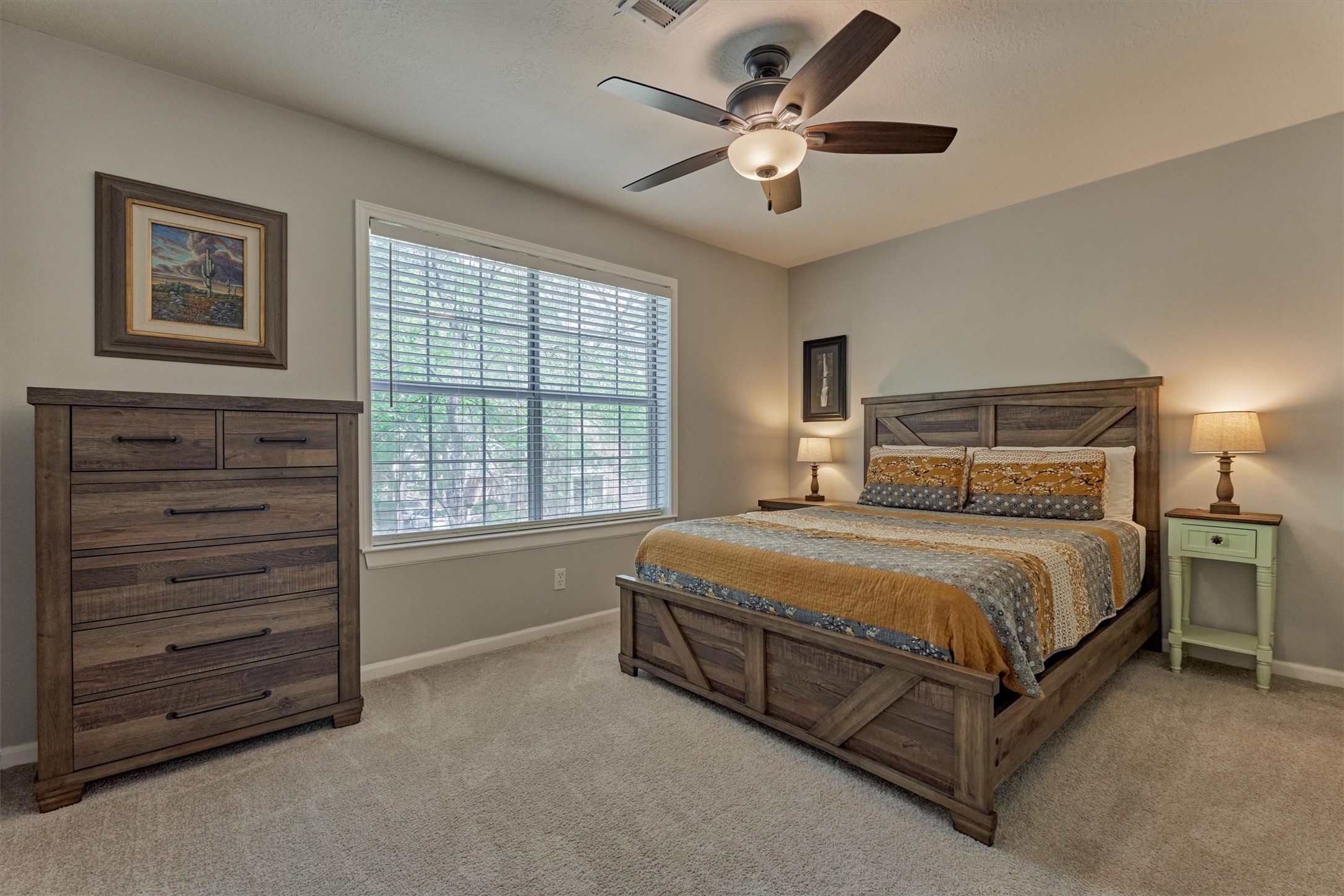 19 Greentwig Place Spring, TX 77381 - Photo 29 of 37 a bedroom with a bed a chandelier and a window