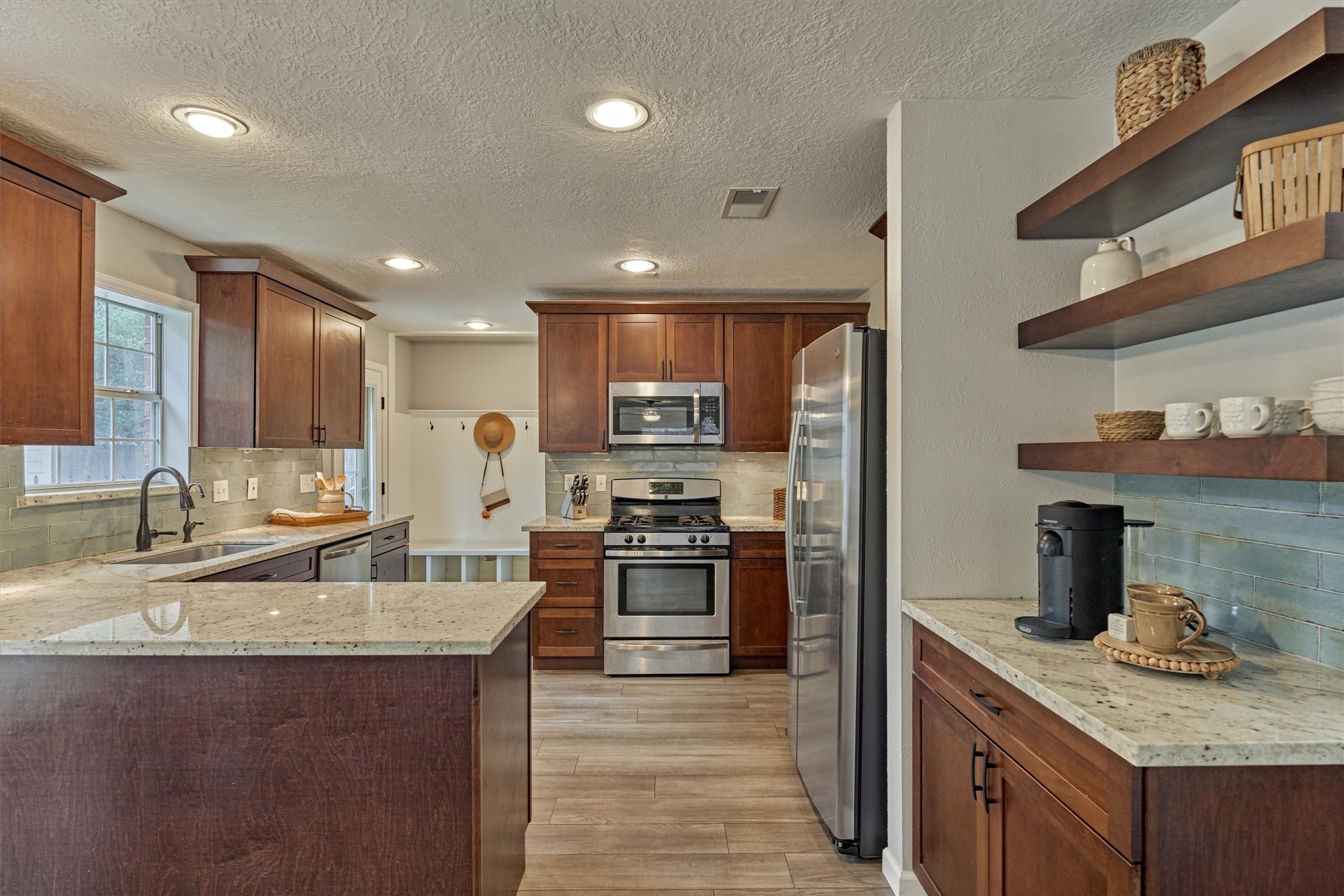 19 Greentwig Place Spring, TX 77381 - Photo 10 of 37 a kitchen with stainless steel appliances granite countertop a sink stove and refrigerator