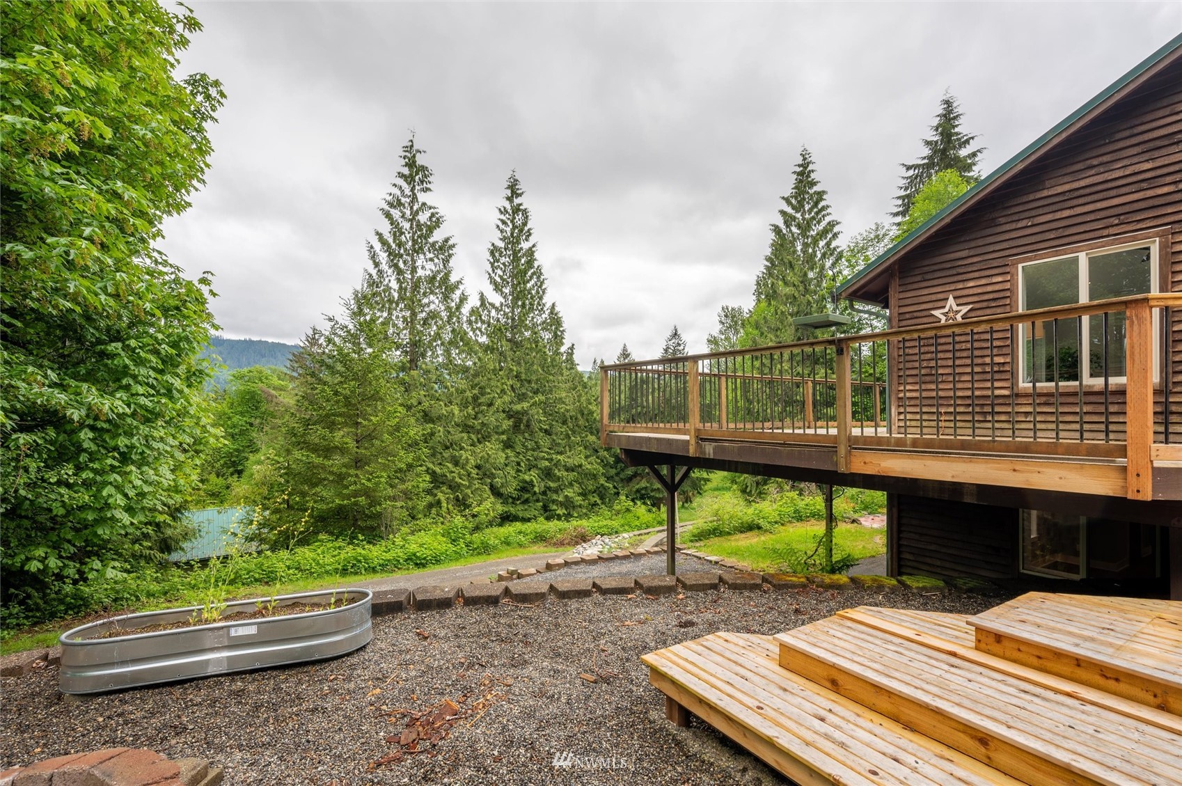 3373 Hillside Road Deming, WA 98244 - Photo 30 of 40 a backyard of a house with table and chairs