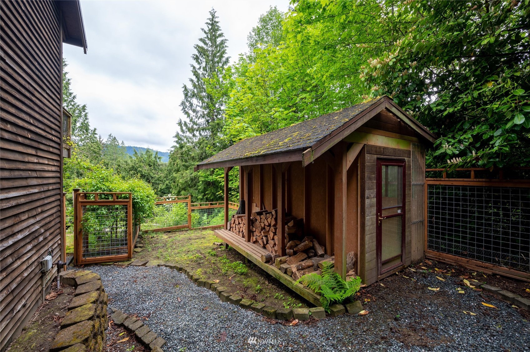 3373 Hillside Road Deming, WA 98244 - Photo 35 of 40 a view of a small barn with wooden fence