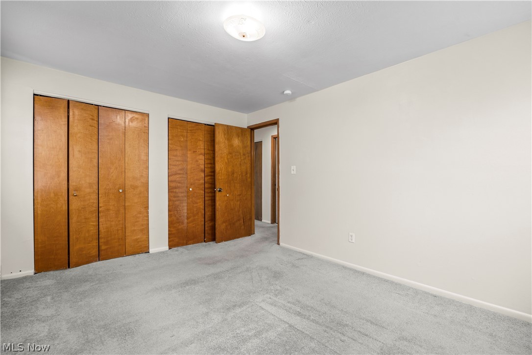 5370 Lee Road, Unit 302 Maple Heights, OH 44137 - Photo 23 of 29 Unfurnished bedroom with two closets and carpet floors