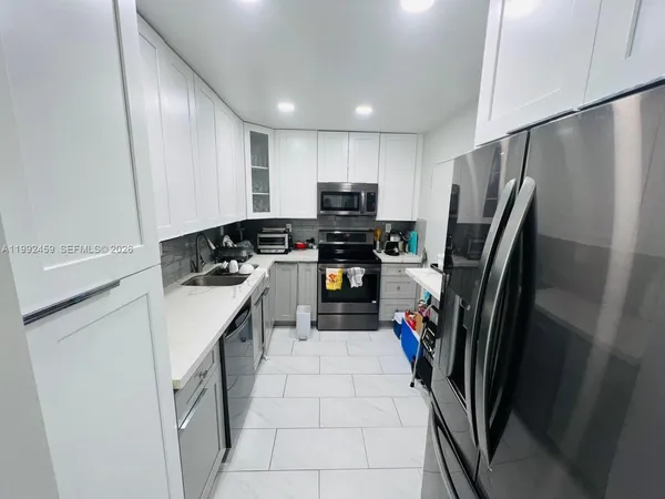 a kitchen with a refrigerator sink and stove