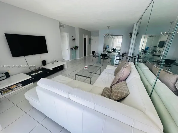 a living room with furniture and a flat screen tv