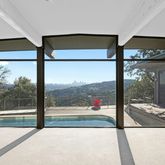 a view of a room with wooden floor and floor to ceiling window