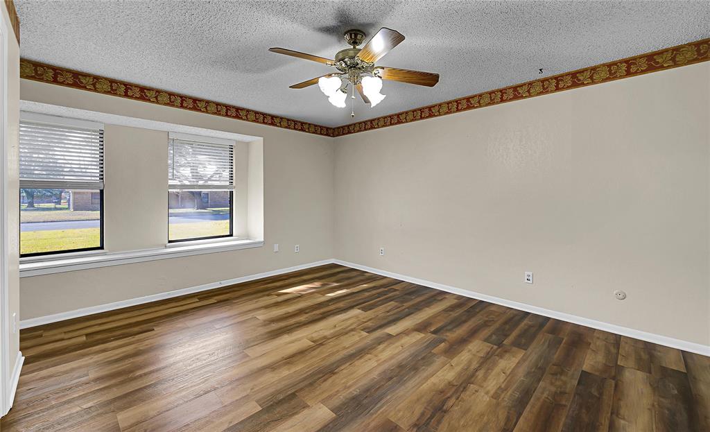 210 Chelsea Drive Hewitt, TX 76643 - Photo 21 of 36 a view of an empty room with window and wooden floor