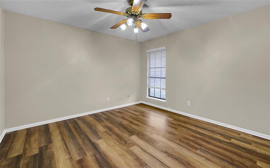 210 Chelsea Drive Hewitt, TX 76643 - Photo 26 of 36 wooden floor in an empty room with a window