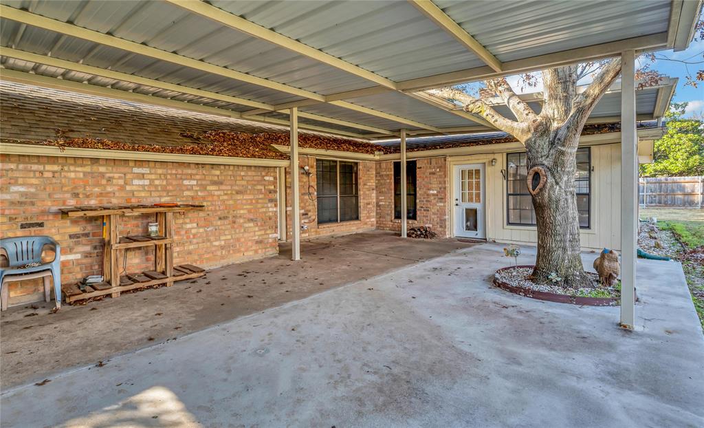 210 Chelsea Drive Hewitt, TX 76643 - Photo 30 of 36 a view of a garage with wooden table and chairs