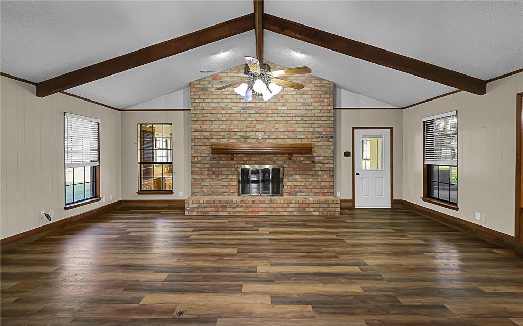 210 Chelsea Drive Hewitt, TX 76643 - Photo 3 of 36 a view of an empty room with wooden floor and a fireplace