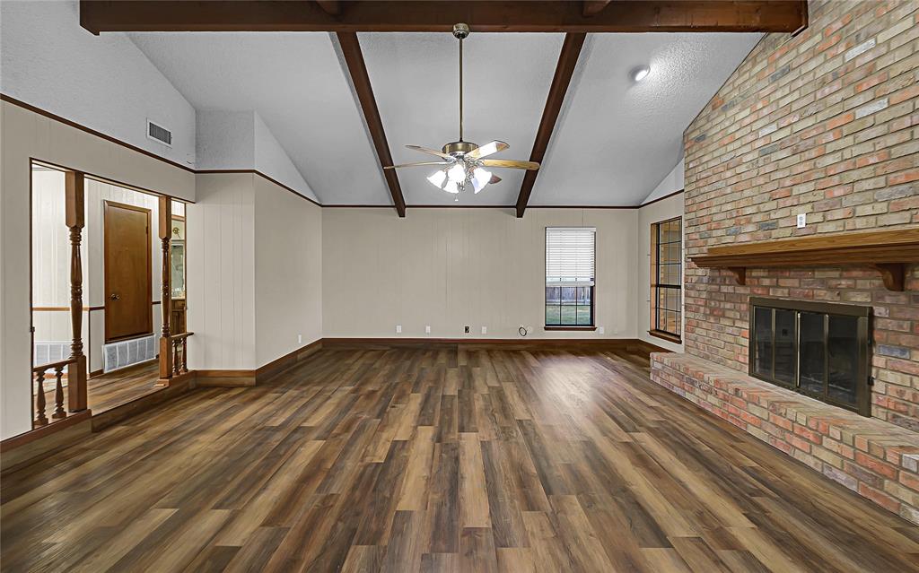 210 Chelsea Drive Hewitt, TX 76643 - Photo 4 of 36 wooden floor in an empty room with a fireplace