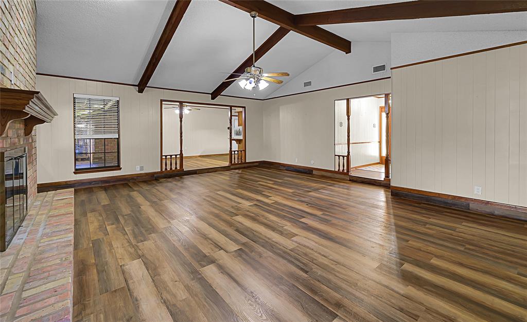 210 Chelsea Drive Hewitt, TX 76643 - Photo 6 of 36 a view of an empty room with wooden floor and a window