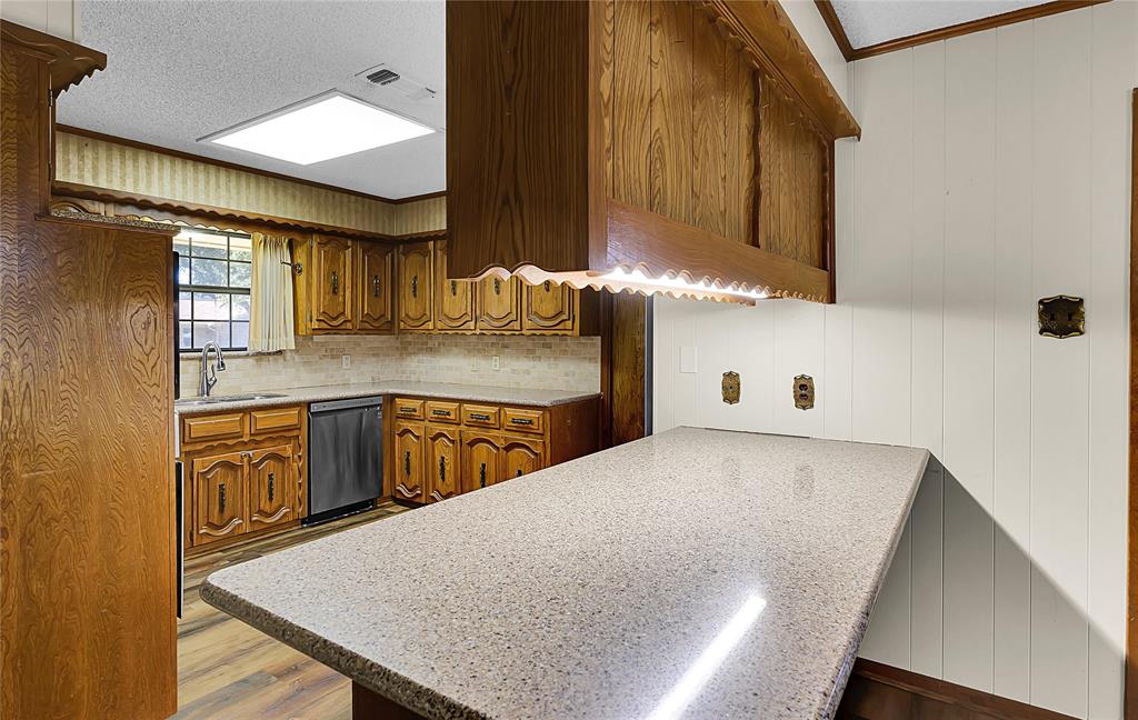 210 Chelsea Drive Hewitt, TX 76643 - Photo 9 of 36 a kitchen with stainless steel appliances granite countertop a sink a stove counter space and cabinets
