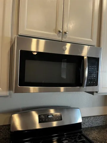 a kitchen with a stove and a microwave