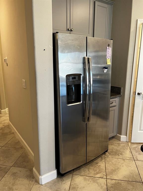 25195 Lambrusco Loop Lutz, FL 33559 - Photo 12 of 36 a metallic refrigerator freezer sitting in a kitchen