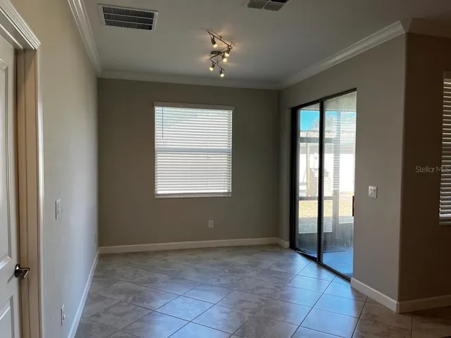 an empty room with windows and closet