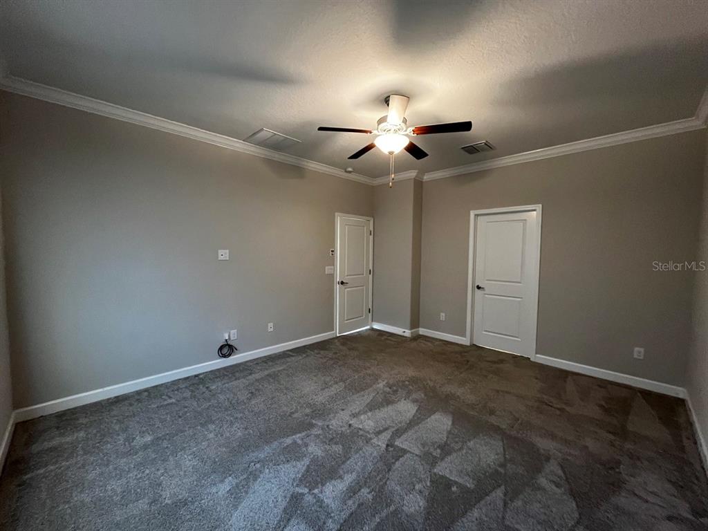 25195 Lambrusco Loop Lutz, FL 33559 - Photo 19 of 36 an empty room with a ceiling fan and a window