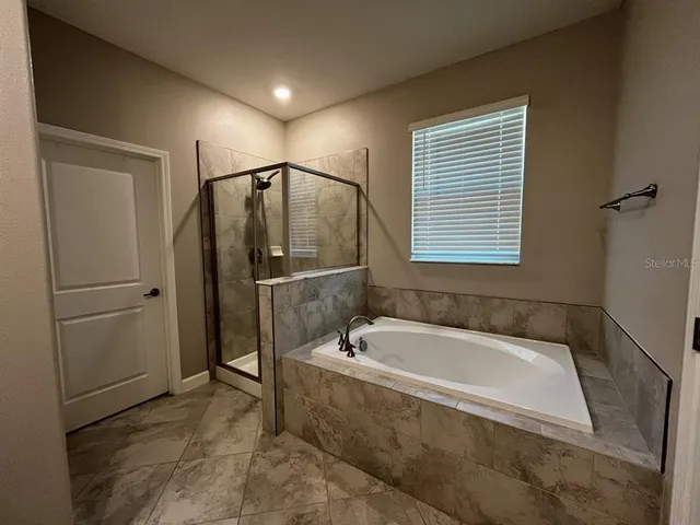 a bathroom with a tub and a shower