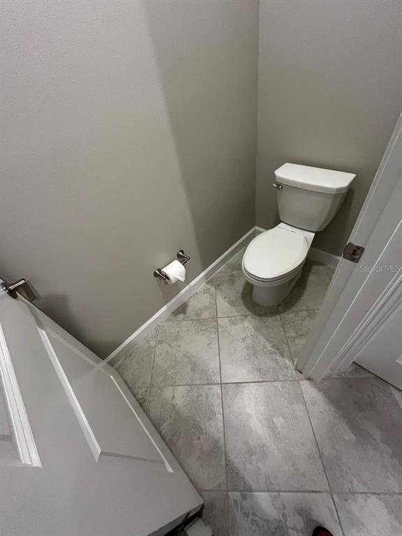 25195 Lambrusco Loop Lutz, FL 33559 - Photo 24 of 36 a bathroom with a toilet and a vanity