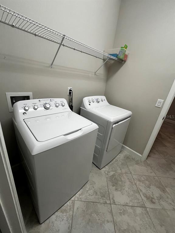 25195 Lambrusco Loop Lutz, FL 33559 - Photo 30 of 36 a utility room with dryer and washer