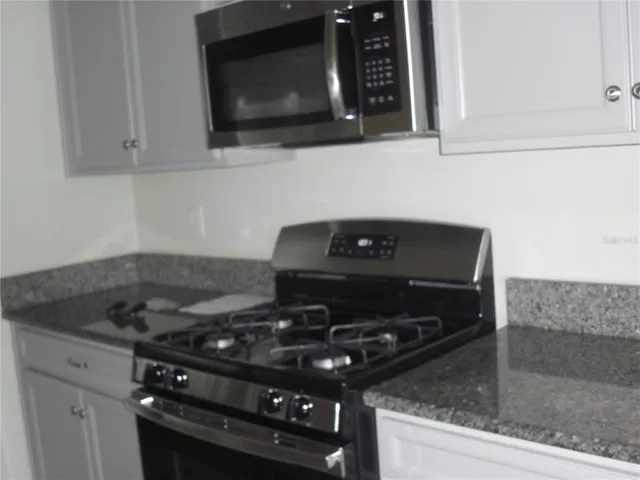 a kitchen with a stove and a microwave