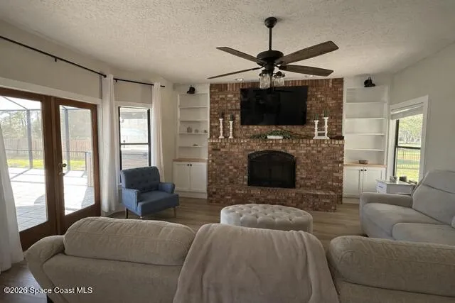 a living room with furniture a flat screen tv and a fireplace
