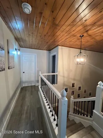 a view of a hallway with stairs