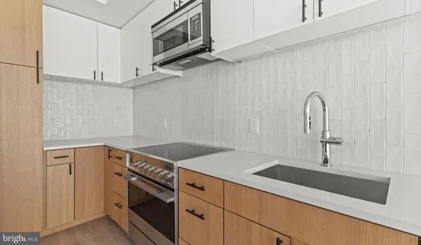 a kitchen with stainless steel appliances granite countertop a sink and a microwave