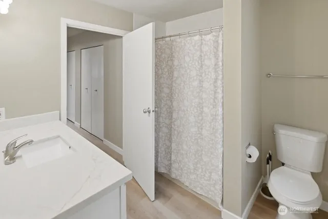 a bathroom with a sink toilet and shower
