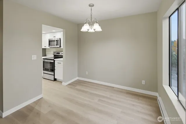 a view of a kitchen with a dishwasher cabinets and a large window