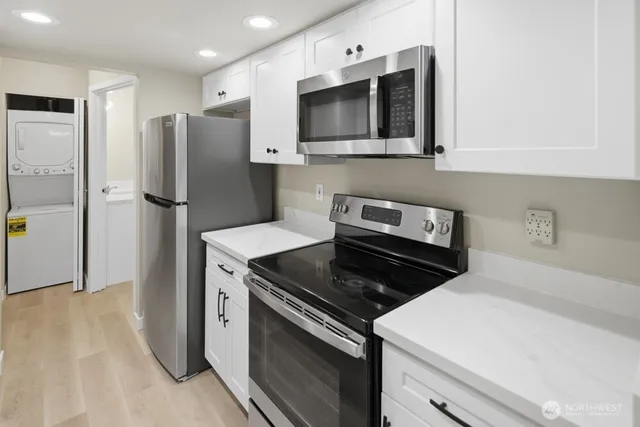 a kitchen with stainless steel appliances a stove microwave and refrigerator